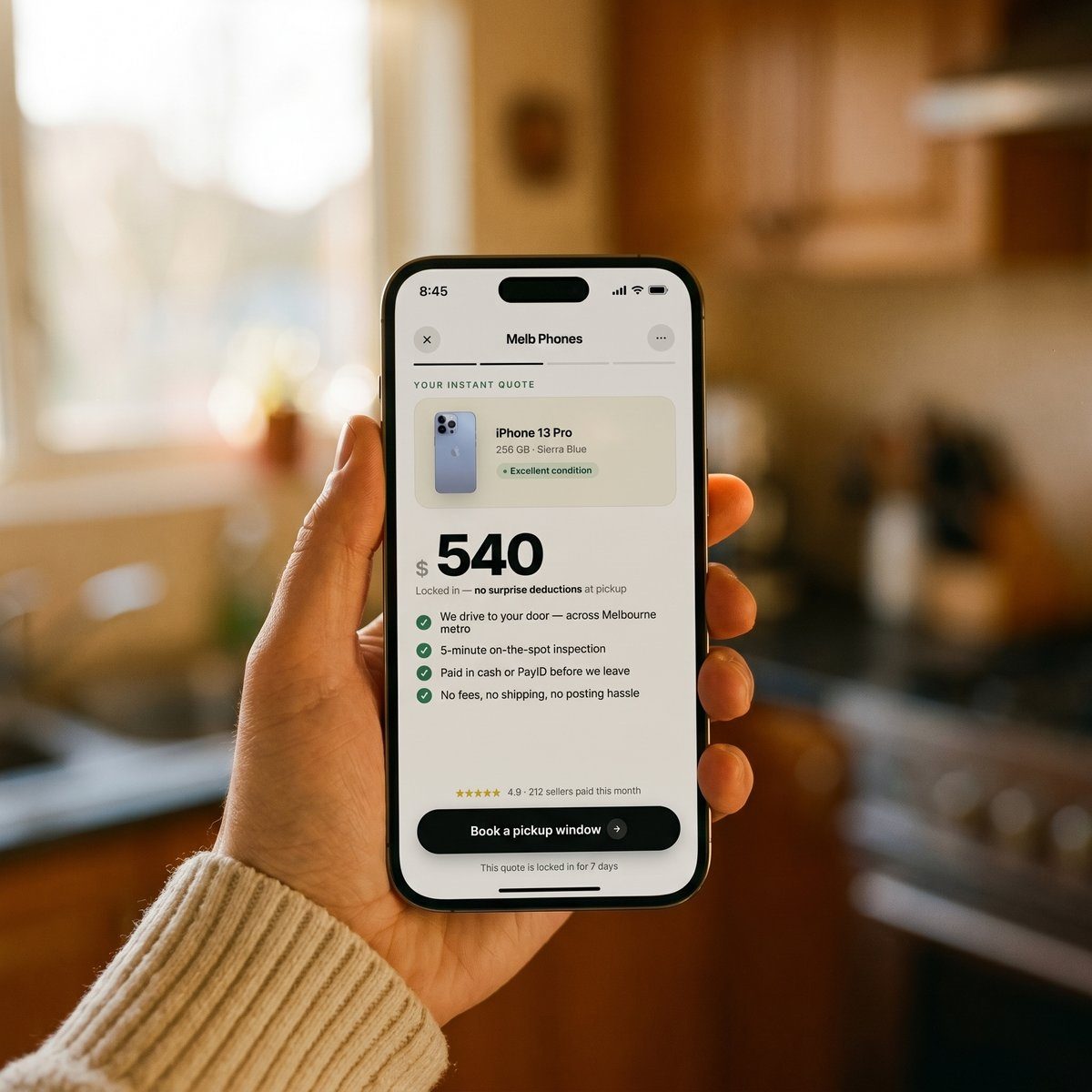 A hand holding an iPhone showing the PhoneFetch instant quote
